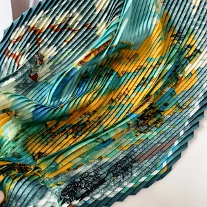 Detail view of a pleated printed satin scarf with abstract landscape pattern.