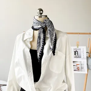 Detailed view of a 70cm pleated printed satin silk scarf styled on a mannequin neck.