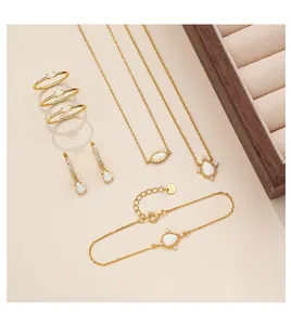 Close-up of S925 silver opal jewelry set including necklaces, rings, and golden bracelet