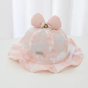 Detail of pink baby lace bucket hat with floral embroidery and large bow