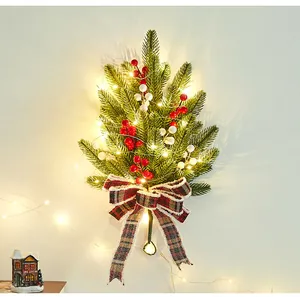 Christmas wall hanging with pine branches, berries, plaid bow and LED lights