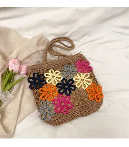 Detailed macro shot of a woven crochet tote bag featuring vibrant floral patterns