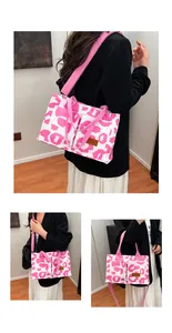 Detailed view showing a large leopard print canvas tote bag with vibrant pink straps