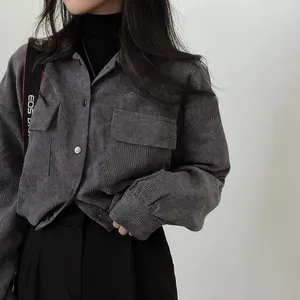 Close-up of vintage gray corduroy cropped long sleeve shirt jacket with pockets.