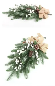 Close-up of artificial Christmas swag featuring pine needles, cones and white berries
