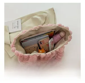 Detailed view of the interior capacity of a large pink plush faux fur tote bag
