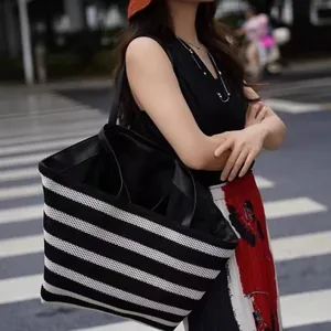 Premium black and white striped woven tote bag with large capacity for vacation use