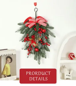 Detailed view of a green Christmas swag with red berries and a striped bow.