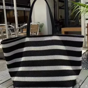 Stylish large capacity black and white striped woven tote bag for beach and vacation