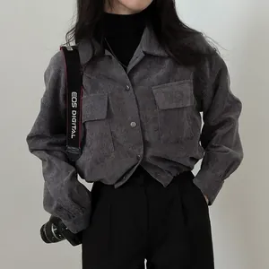 Detailed texture of grey corduroy short jacket with lapel and metal buttons