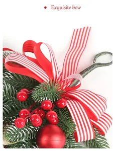 Close-up detail of a festive Christmas wreath featuring a red striped bow and pine