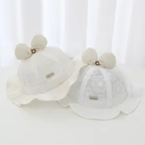 Elegant white lace baby sun hat with cute bow detail and floral embroidery patterns