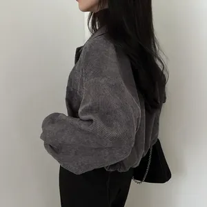 Side view detail of a vintage dark grey corduroy loose jacket with drawstring hem.