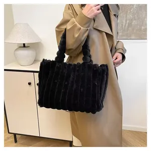 Close-up of black plush tote bag with pleated faux fur texture and large capacity.