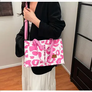 Detailed close-up view of a pink leopard print large capacity tote bag on model