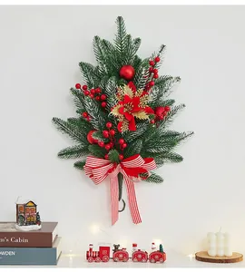 Artificial Christmas pine teardrop swag with red berries and striped bow for door decor