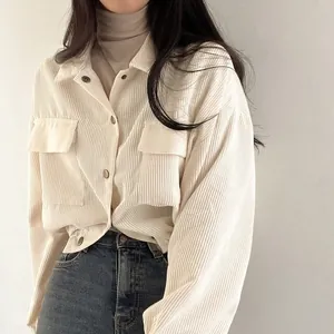 Close-up detail of cream white corduroy shirt jacket with minimalist retro style