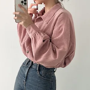 Close-up detail of a pink corduroy cropped shirt jacket with a retro loose fit.