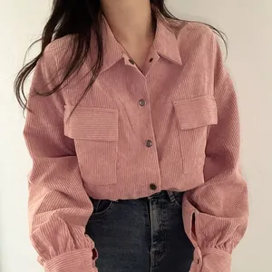 Detailed view of a vintage pink corduroy long-sleeve shirt with lapel and pockets