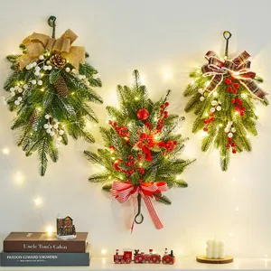 Festive artificial Christmas teardrop swags with warm LED lights and assorted decorative bows