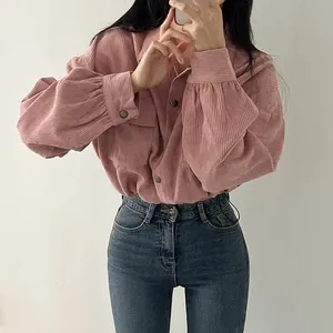 Detail of pink corduroy long-sleeve shirt with vintage lapel and drawstring cuffs.