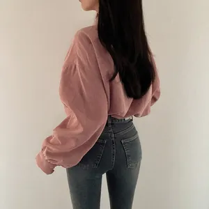 Back view of pink corduroy long sleeve shirt showing fabric texture and loose fit
