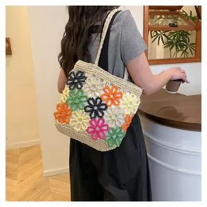 Handcrafted crochet tote bag with colorful hollow flower patterns shown on model