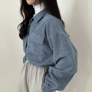 Detailed view of a vintage blue corduroy drawstring shirt jacket with a retro collar.