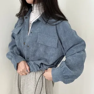 Close-up view of a light blue corduroy shirt featuring an adjustable drawstring hem