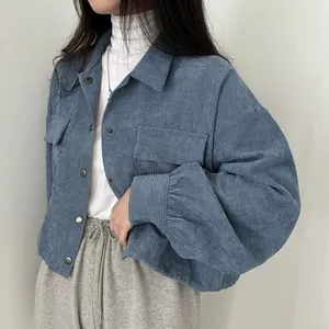 Detail view of blue corduroy texture and button details on a vintage minimalist jacket