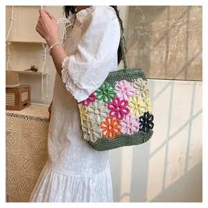 Handmade colorful floral crochet woven tote bag for women shown with a white dress.