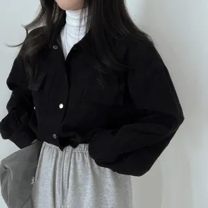 Detailed view of the black corduroy texture on this vintage minimalist loose jacket