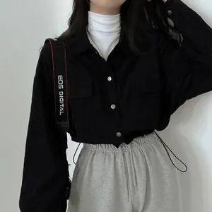 Detailed shot of a black retro corduroy cropped long sleeve shirt jacket for women
