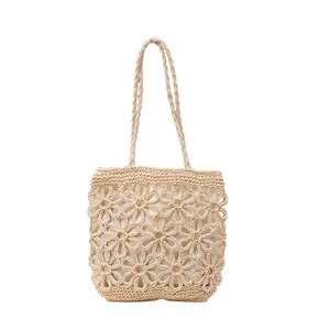 Detailed view of cream hand-woven tote bag featuring exquisite floral hollow patterns.