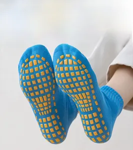 Close-up detail of blue yoga socks featuring yellow PVC anti-slip massage particles