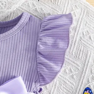Close-up view of purple ribbed flutter sleeve princess dress with elegant satin bow detail