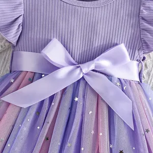 Detailed view of girls' purple mesh princess dress with satin bow belt and star sequins