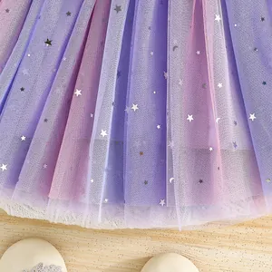 Detailed view of elegant gradient mesh tulle skirt with silver star and moon sequins
