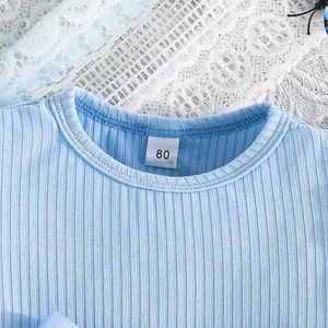 Close-up of blue ribbed neckline and size 80 tag of a toddler princess dress.