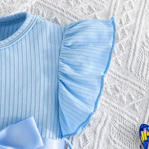 Close-up of light blue ribbed dress detail with ruffled sleeve and satin bow
