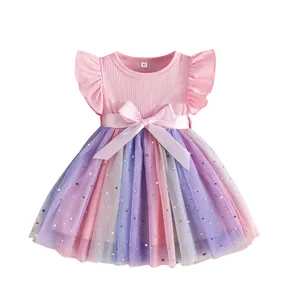 Close-up of pink toddler princess dress featuring starry rainbow tulle skirt and bow