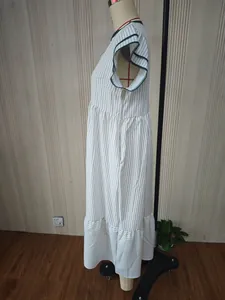 Detailed side view of a striped ladies' dress with double ruffle sleeves and contrast trim.