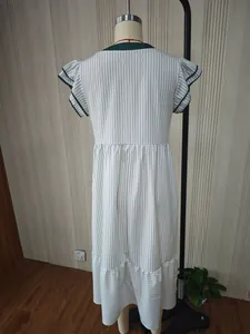 Back view detail of a women's striped dress with ruffled sleeves and contrast green trim