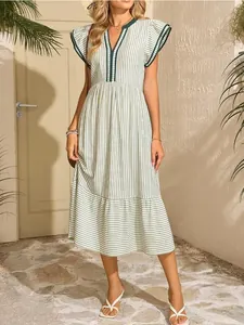 Detail view of a green and white striped V-neck dress with double ruffled sleeves