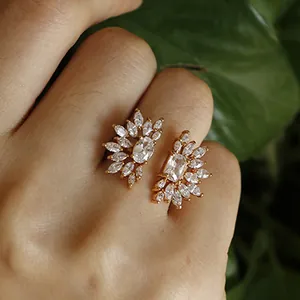 Detailed view of a gold-tone open sunburst ring with sparkling marquise crystals