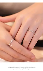 Detailed view of Mobius 999 silver couple rings with sparkling zircon stones on hands