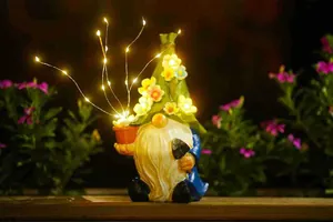 Illuminated solar garden gnome outdoor ornament with LED flower hat and firefly string lights