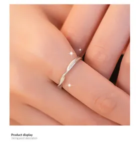 Close-up of minimalist Mobius sterling silver ring with unique twist design on finger