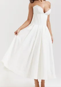 Elegant white corset strapless midi dress with a voluminous pleated A-line skirt