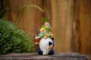 Detailed view of a solar garden gnome figurine with flower hat and glowing lights.